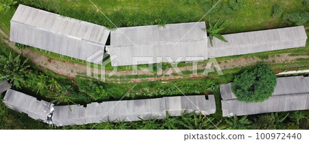 Drone photo of the view of the goat pen from above. Which is surrounded by many trees 100972440