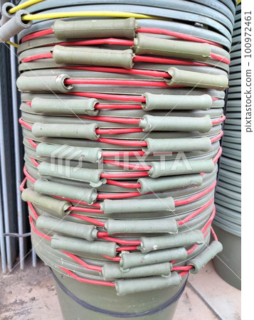 Neat stack of multi-colored buckets in a builder's shop Neat stack of multi-colored buckets in a builder's shop 100972461