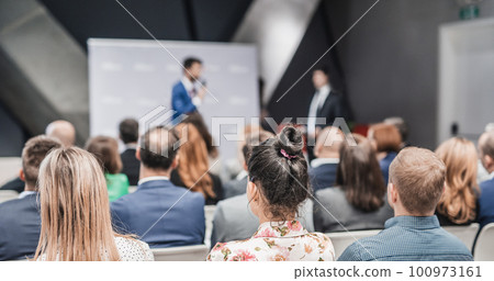 Pitch presentation and project discussion at business convention or team meeting. Audience at the conference hall. Business and entrepreneurship symposium 100973161