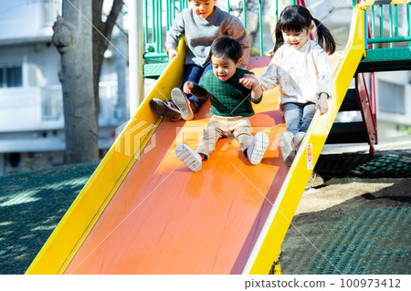 Children playing with playground equipment Park Children playing with playground equipment Park 100973412