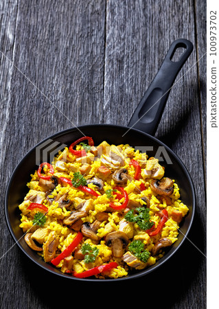 Chicken Paella with mushrooms, red pepper, spices Chicken Paella with mushrooms, red pepper, spices 100973702