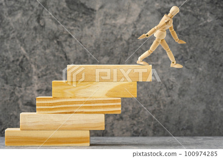 Wooden mannequin falling down from stairs Wooden mannequin falling down from stairs 100974285