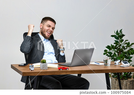 man sitting on chair at table and resting, using laptop man sitting on chair at table and resting, using laptop 100975084