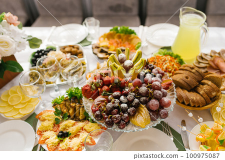 Banquet table with food and snacks at a wedding, birthday or party 100975087