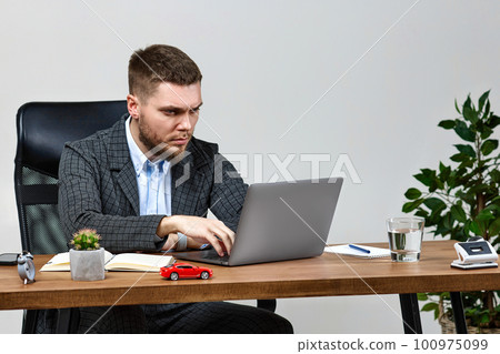 man sitting on chair at table and resting, using laptop man sitting on chair at table and resting, using laptop 100975099