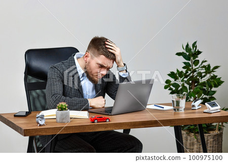 man sitting on chair at table and resting, using laptop man sitting on chair at table and resting, using laptop 100975100
