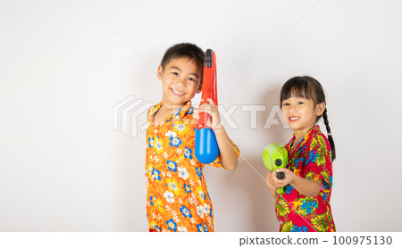 Happy Songkran Day, Asian kid girl and boy holding plastic water gun, Thai child funny smiling hold toy water pistol, isolated on white background, Thailand Songkran festival national culture concept 100975130
