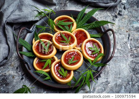 Biscuit with strawberry jam and marijuana leaf Biscuit with strawberry jam and marijuana leaf 100975594