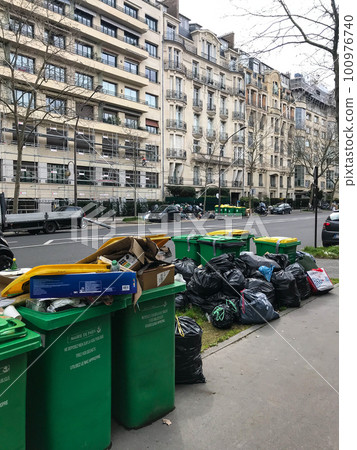 Paris, France - March 23th, 2023: Some garbage in a row in the street of Paris during the binmen 100976740