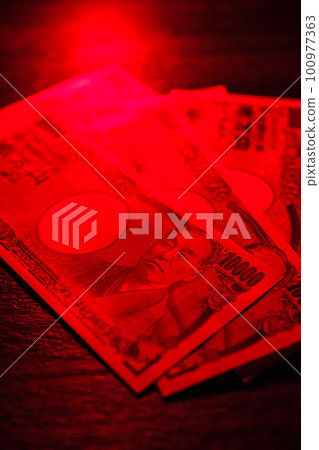 banknotes on red background 100977363