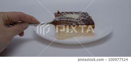 Turkish traditional dessert of ramadan on white background .tralice. Three milk cake turkish style. close-up Turkish traditional dessert of ramadan on white background .tralice. Three milk cake turkish style. close-up 100977524