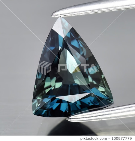 Natural gemstone blue sapphire on gray background Natural gemstone blue sapphire on gray background 100977779