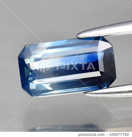 Natural gemstone blue sapphire on gray background Natural gemstone blue sapphire on gray background 100977780