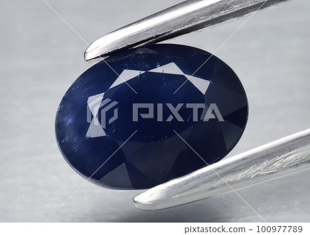 Natural gemstone blue sapphire on gray background Natural gemstone blue sapphire on gray background 100977789