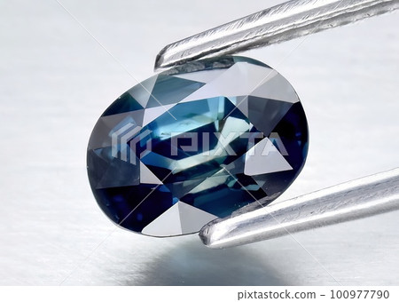 Natural gemstone blue sapphire on gray background 100977790
