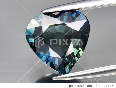 Natural gemstone green sapphire on gray background Natural gemstone green sapphire on gray background 100977796