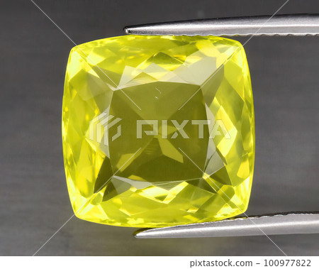 Natural gemstone yellow quartz on gray background 100977822