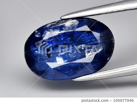 Natural gemstone blue kyanite on gray background 100977846