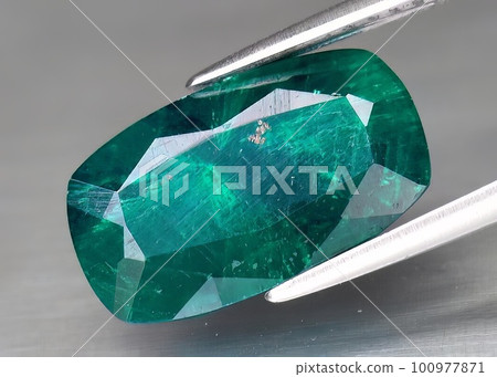 Natural gemstone green dioptase on a gray background 100977871