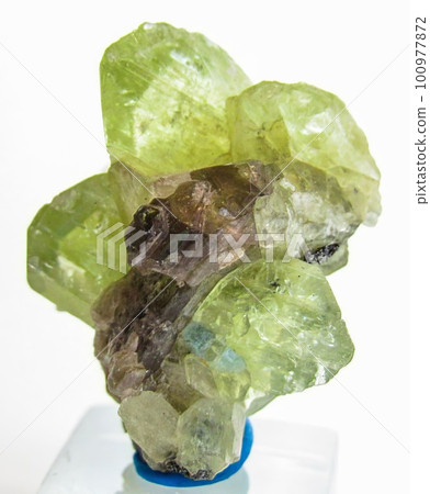 Natural gemstone green dioptase on a gray background 100977872