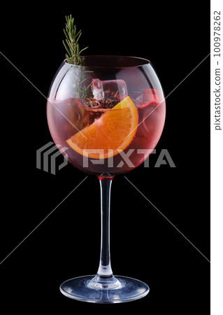 Cold sangria with orange and rosemary in a wine glass Cold sangria with orange and rosemary in a wine glass 100978262