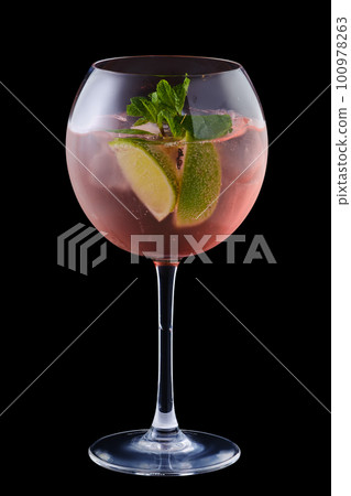 Cold sangria with lime and mint in a wine glass Cold sangria with lime and mint in a wine glass 100978263