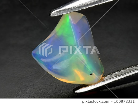 Natural precious stone opal on a black background Natural precious stone opal on a black background 100978331