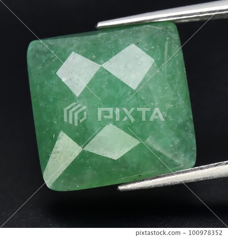 Natural gemstone green aventurine on black background Natural gemstone green aventurine on black background 100978352