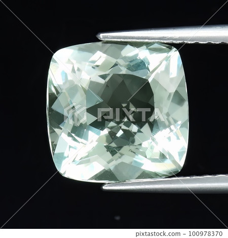 Natural gemstone green amethyst prasiolite on gray background 100978370