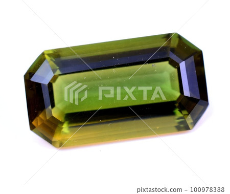 Natural gem green tourmaline on gray background 100978388