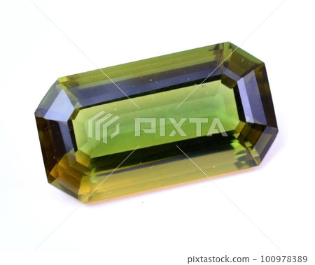 Natural gem green tourmaline on gray background 100978389