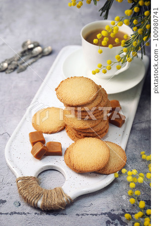 Palets bretons, french cookies. Salted caramel Shortbread Breton cookies, cup of coffee and mimosa 100980741