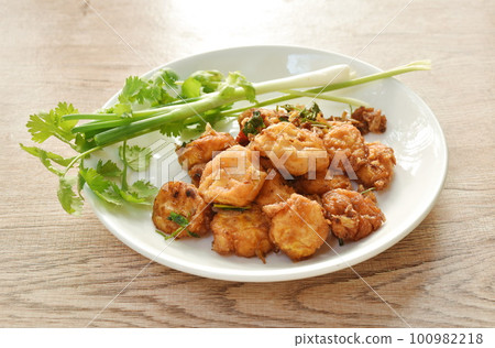 crispy tofu stuffed flour dressing garlic and pepper with spring onion couple parsley on plate 100982218