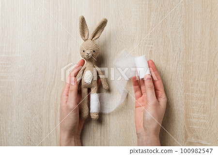 Concept of child injury with bunny with bandage 100982547