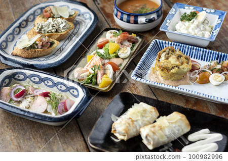 selection of many different tapas on rustic wood table selection of many different tapas on rustic wood table 100982996