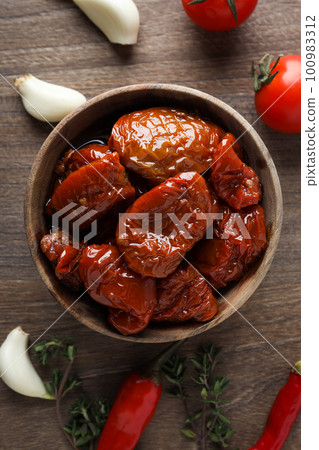 Concept of tasty food - sun-dried tomato, top view 100983312