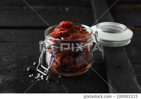 Concept of tasty food - sun-dried tomato Concept of tasty food - sun-dried tomato 100983315