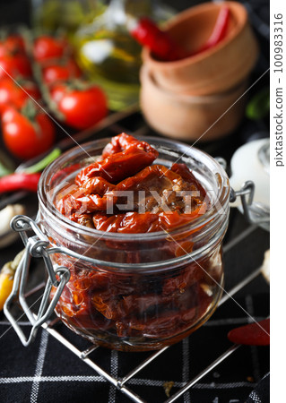 Concept of tasty food - sun-dried tomato Concept of tasty food - sun-dried tomato 100983316