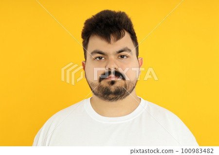 Concept of people, young fat man on yellow background Concept of people, young fat man on yellow background 100983482