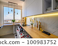 A contemporary white kitchen with drawers extended 100983752