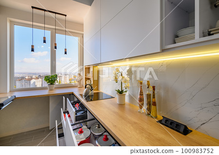 A contemporary white kitchen with drawers extended A contemporary white kitchen with drawers extended 100983752