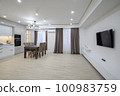 Huge white luxury kitchen in a studio apartment interior 100983759