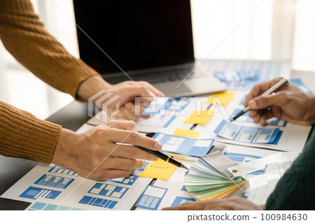 Creative digital development agency. developer team brainstorming on their project with laptop, smartphone and digital tablet. Creative digital development agency. developer team brainstorming on their project with laptop, smartphone and digital tablet. 100984630