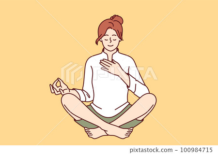 Woman meditates with hand on heart and wishes to heal herself through yoga and spiritual practice 100984715