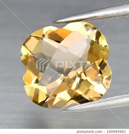 Natural gemstone orange topaz imperial on a gray background 100984982