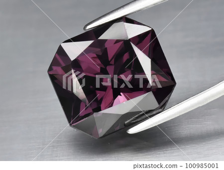 Natural gemstone pink spinel on gray background 100985001
