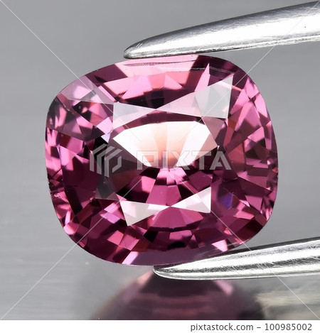 Natural gemstone pink spinel on gray background 100985002