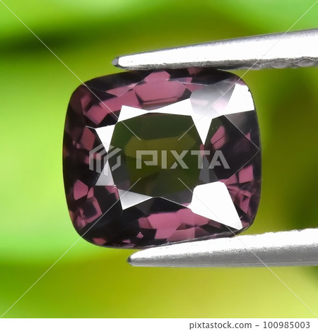 Natural gemstone pink spinel on gray background 100985003