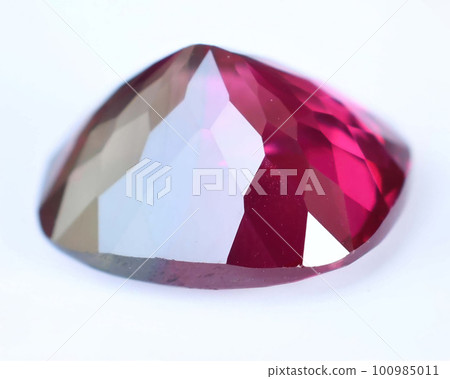 Natural gemstone red rhodolite garnet on gray background Natural gemstone red rhodolite garnet on gray background 100985011