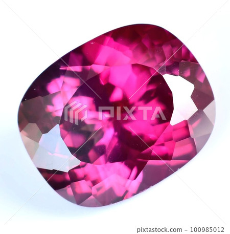 Natural gemstone red rhodolite garnet on gray background Natural gemstone red rhodolite garnet on gray background 100985012